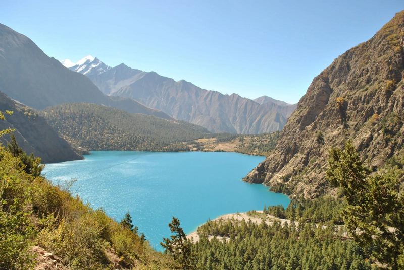 A lake between forested slopes