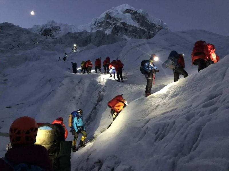 Climbers on a pre-dawn summit push